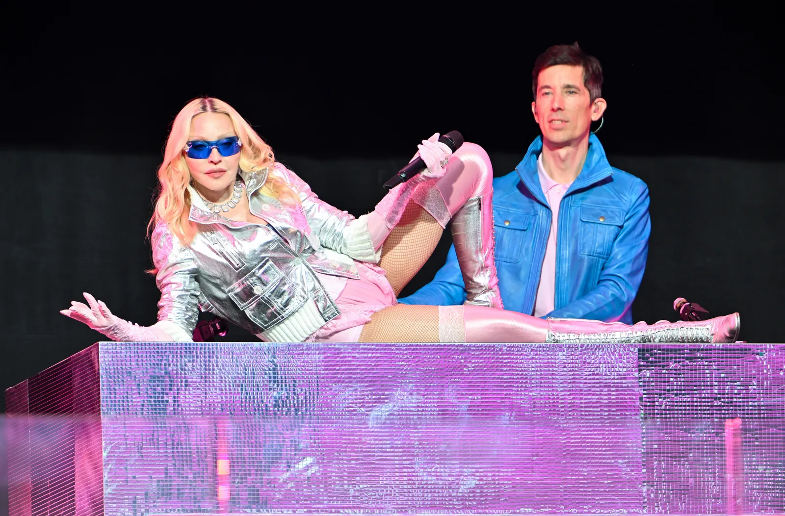 Madonna in silver and pink onstage with Stuart Price during the Confessions II era reveal.